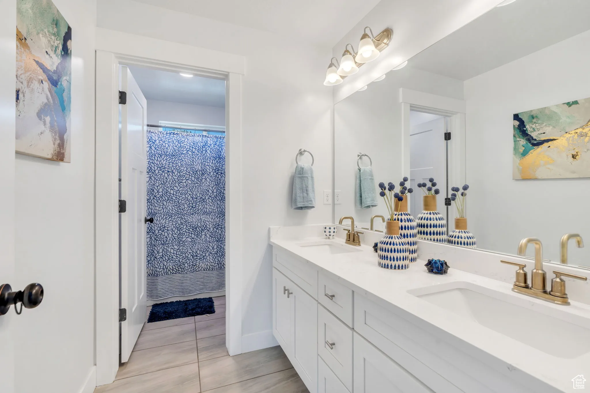 Bathroom featuring double vanity and tile patterned flooring