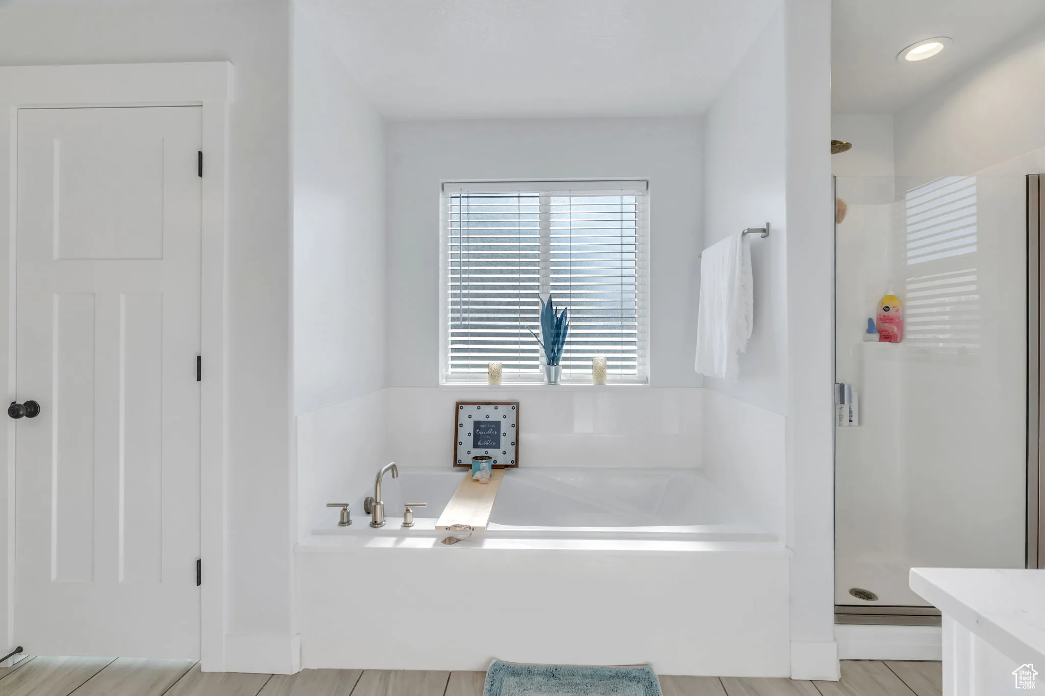 Full bath featuring a shower stall and a garden tub