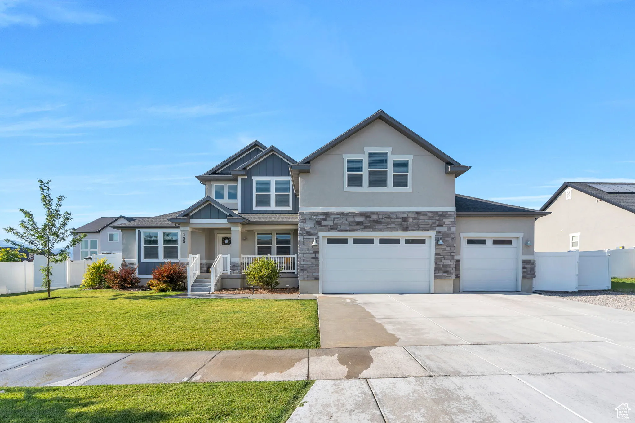 Craftsman inspired home featuring stone siding, concrete driveway, stucco siding, and an attached garage