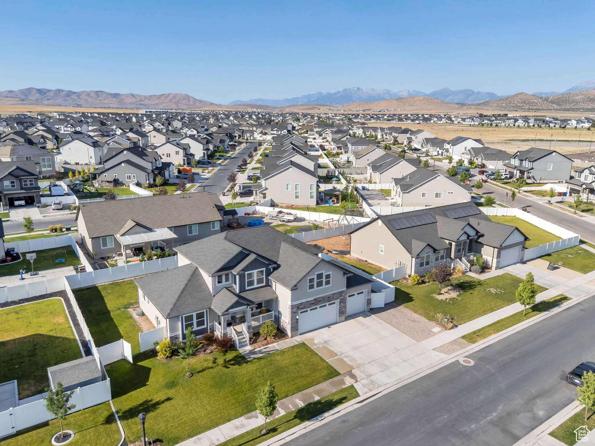 Aerial perspective of suburban area featuring a mountain backdrop