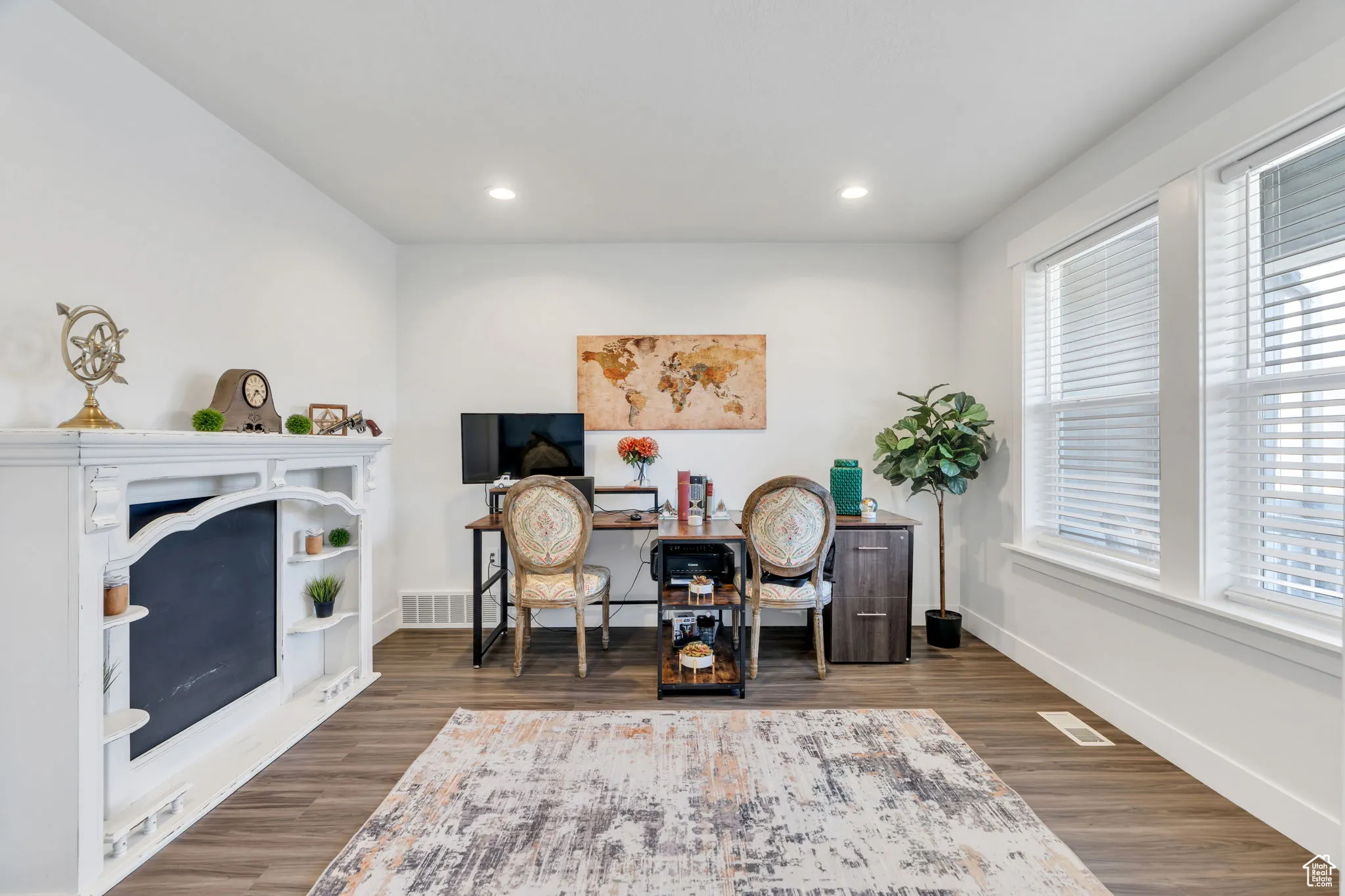 Office space with wood finished floors and recessed lighting