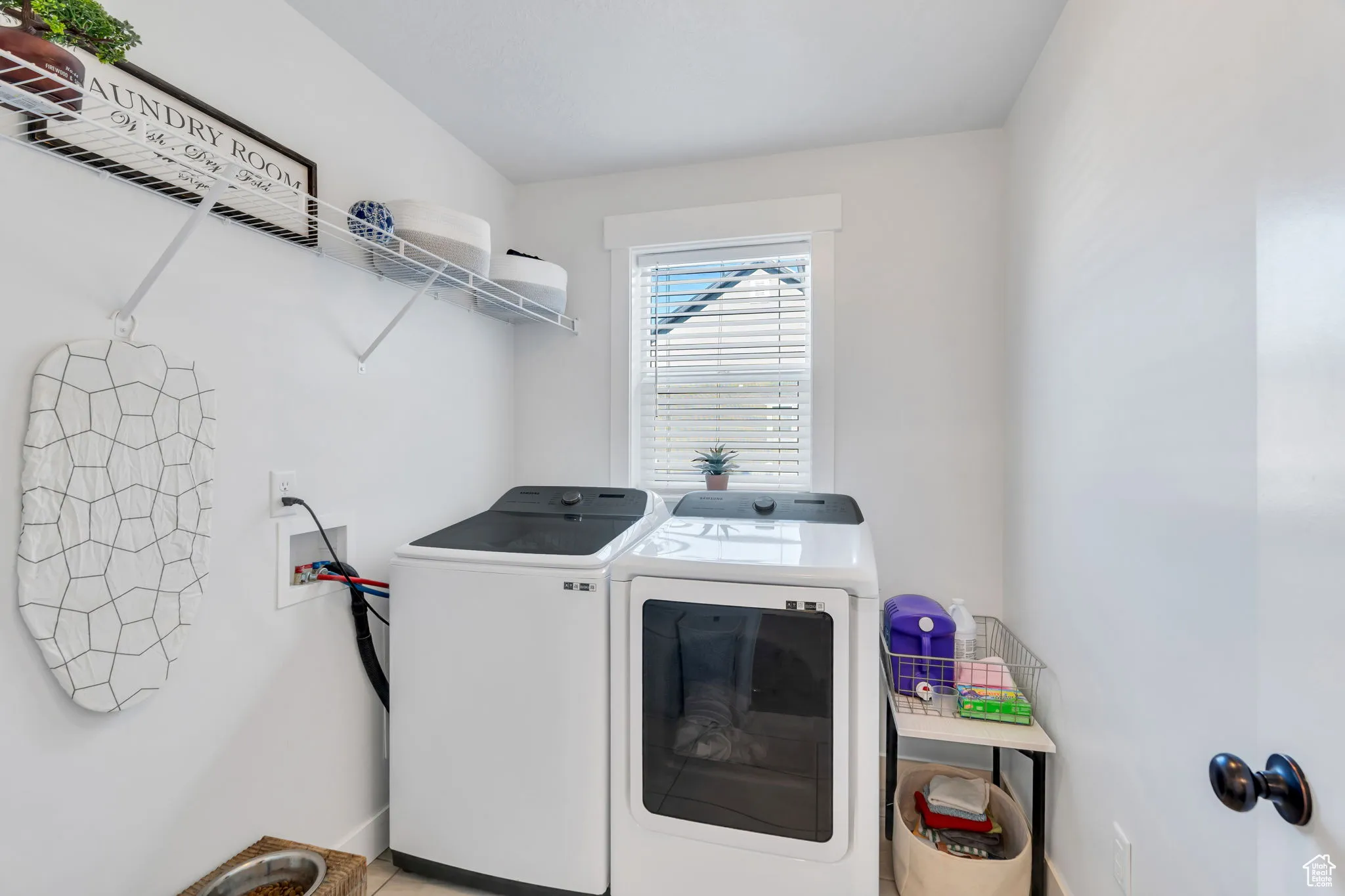 Laundry area with separate washer and dryer and baseboards