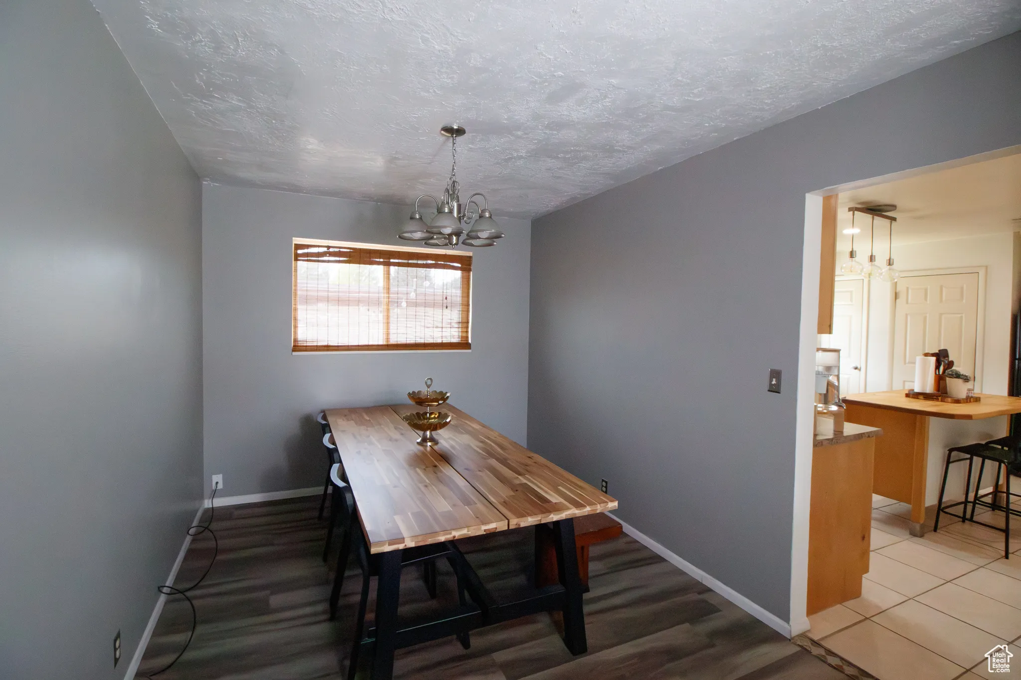 Dining space with a chandelier and a textured ceiling