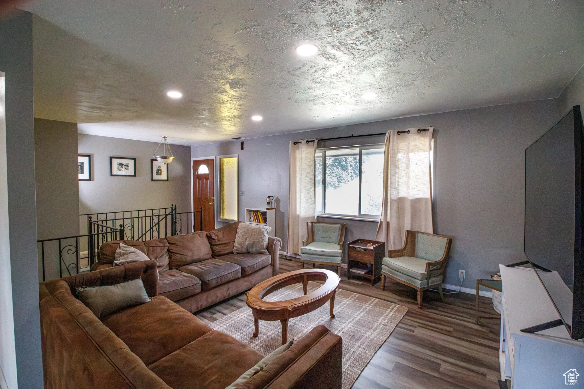 Living room with wood finished floors and recessed lighting