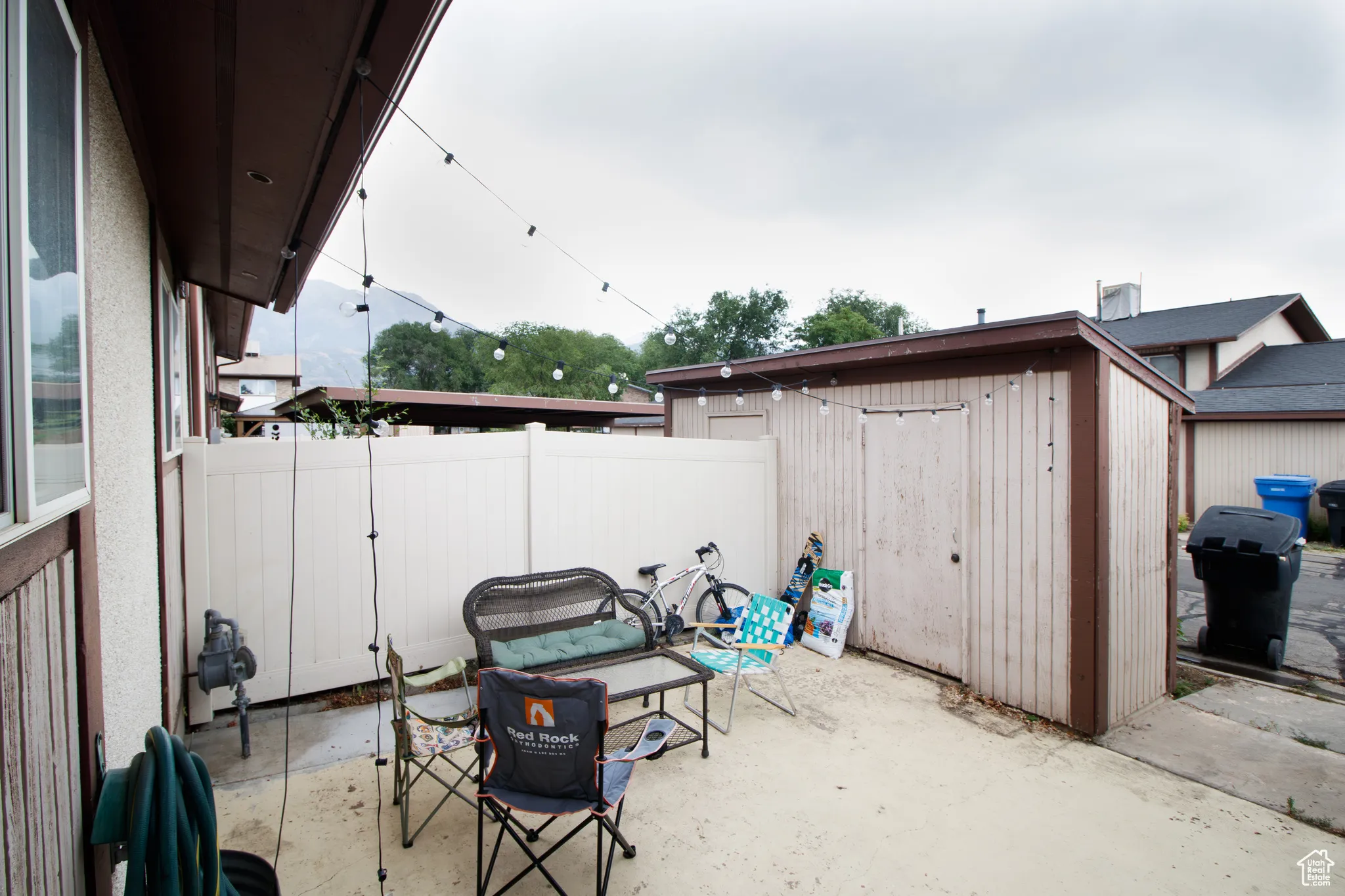 View of patio / terrace with a storage shed and a grill