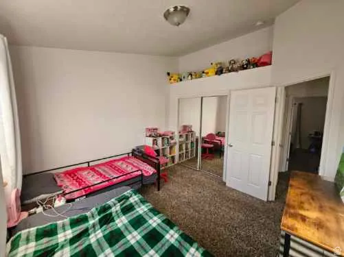 Bedroom featuring carpet floors and a closet