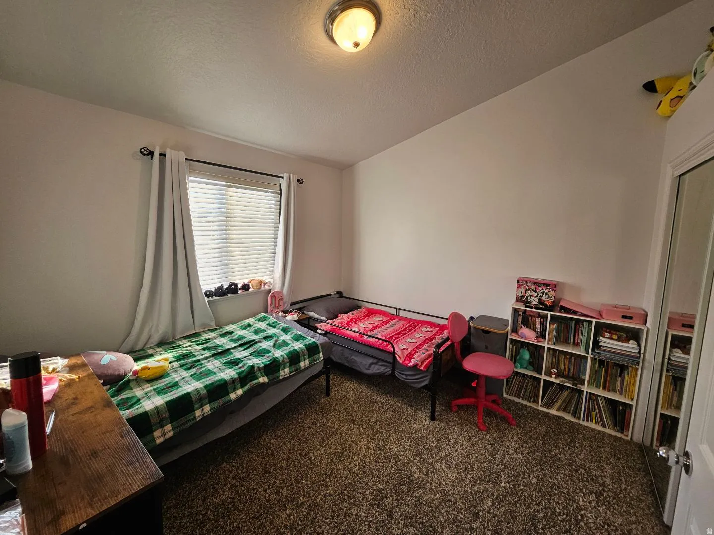 Bedroom with a textured ceiling and carpet flooring