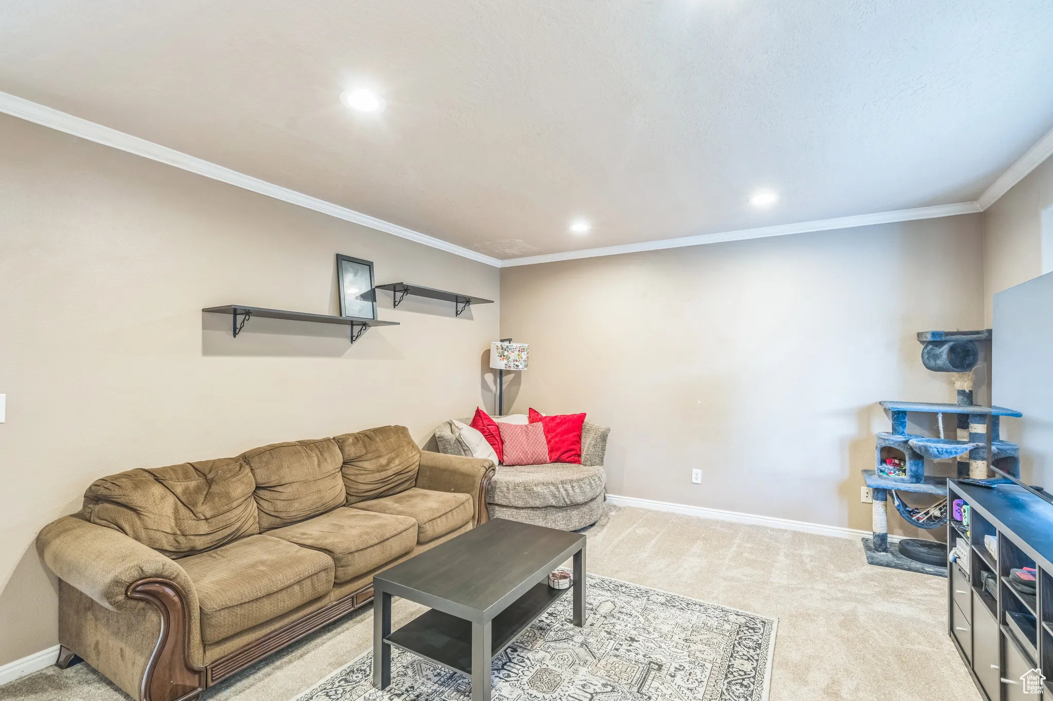 Living area featuring light carpet, recessed lighting, and crown molding