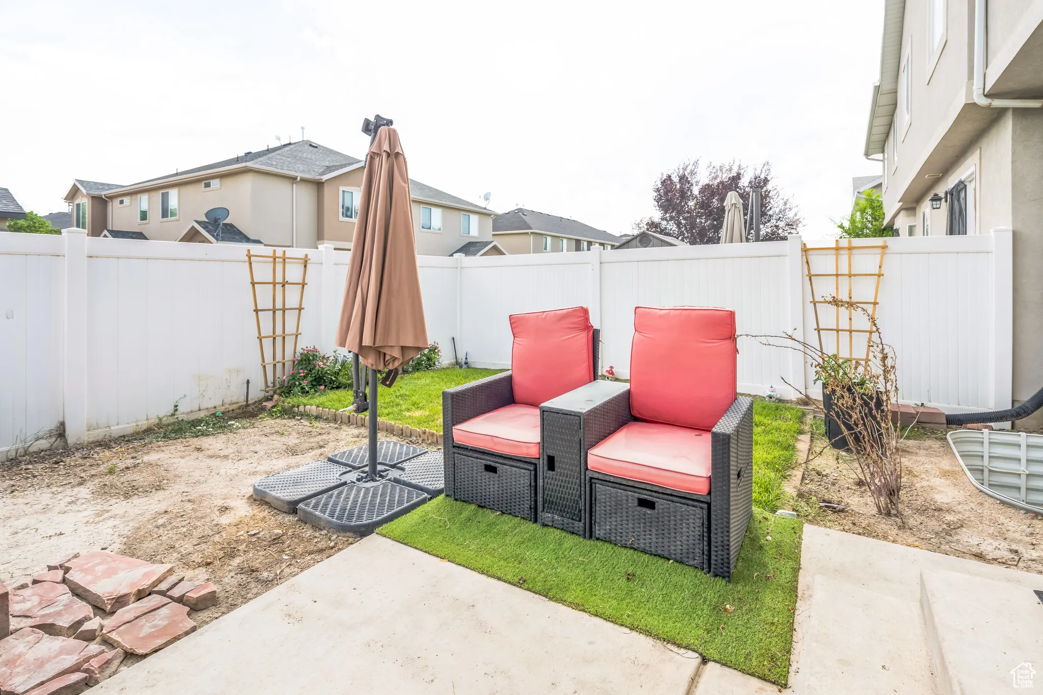 Fenced backyard with a patio area