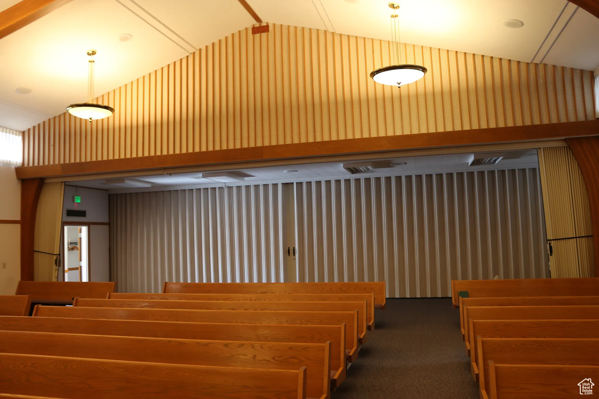 View of chapel with accordion wall at the rear, separating pews from additional space for seating