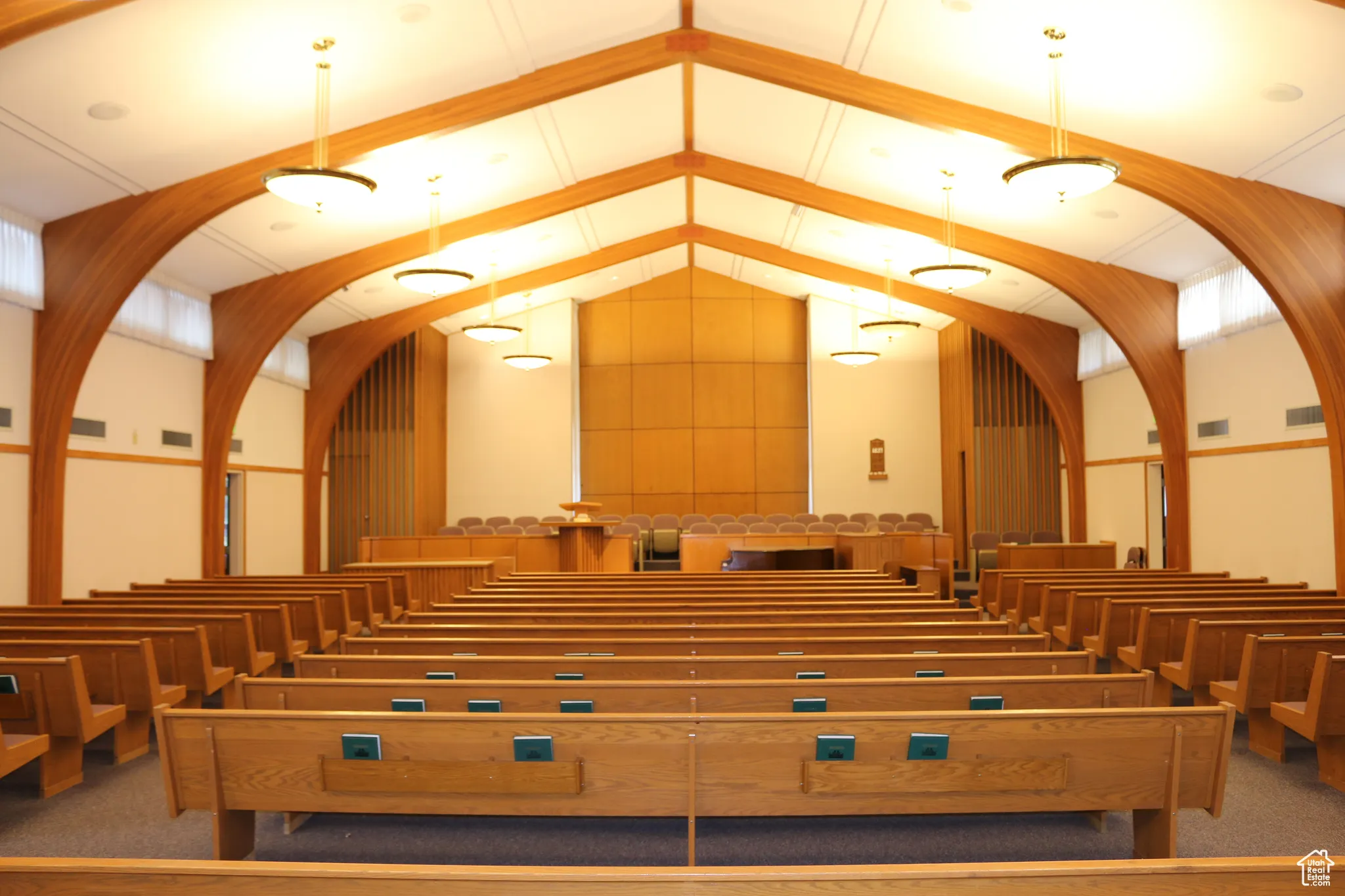 Additional view of chapel with wood pews and raised dais