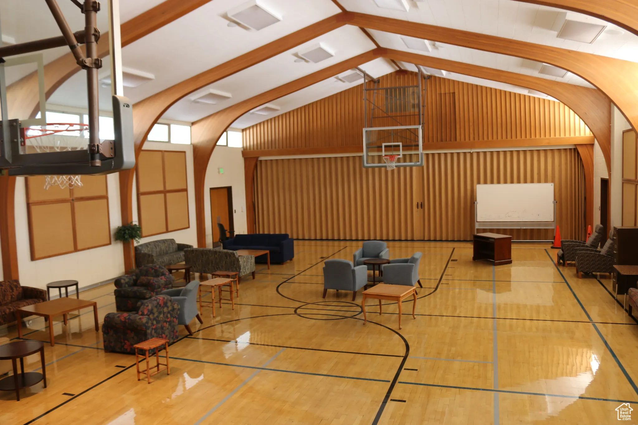 View of interior basketball court, separated from chapel by accordion wall