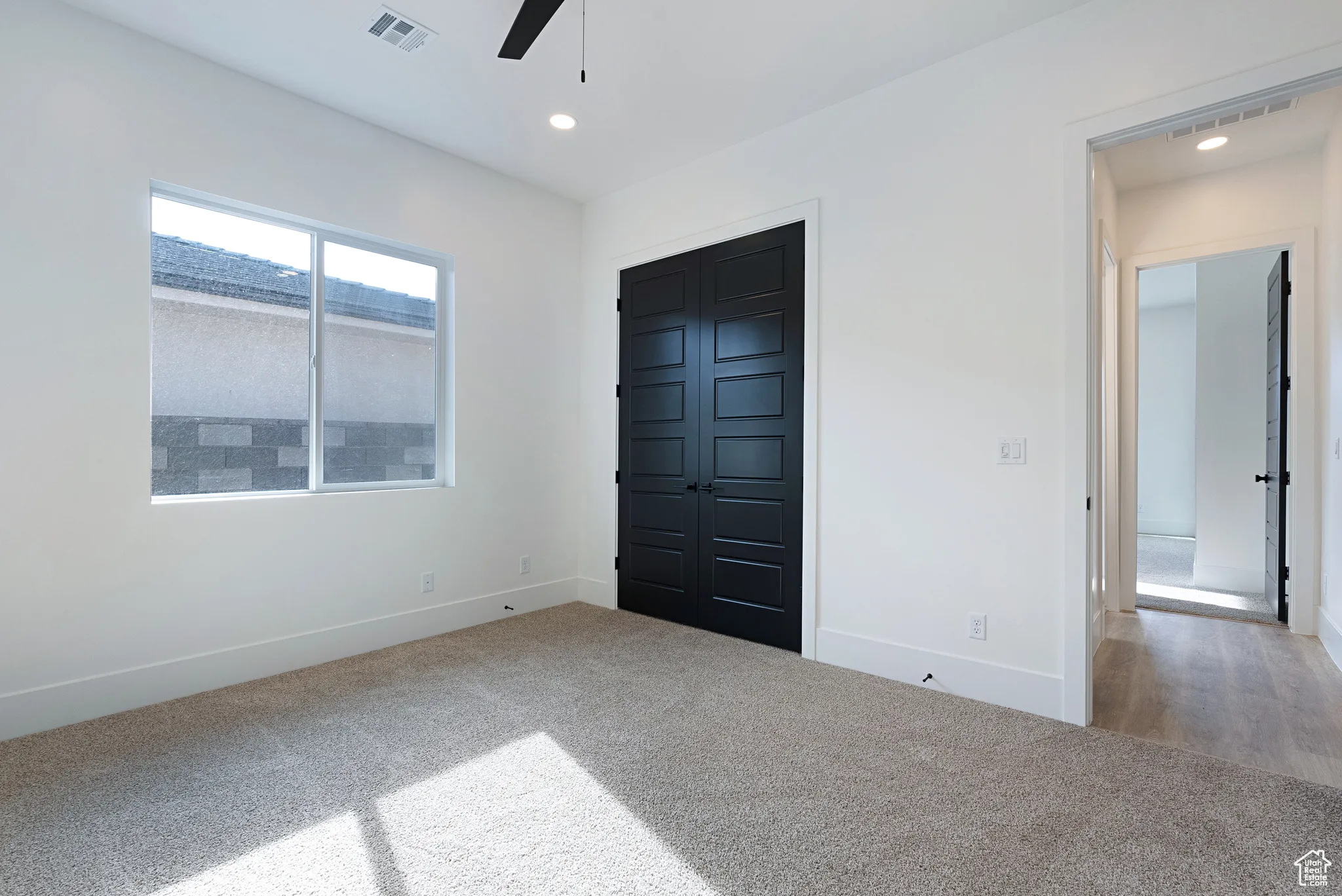 Unfurnished bedroom with carpet floors, recessed lighting, a closet, and a ceiling fan