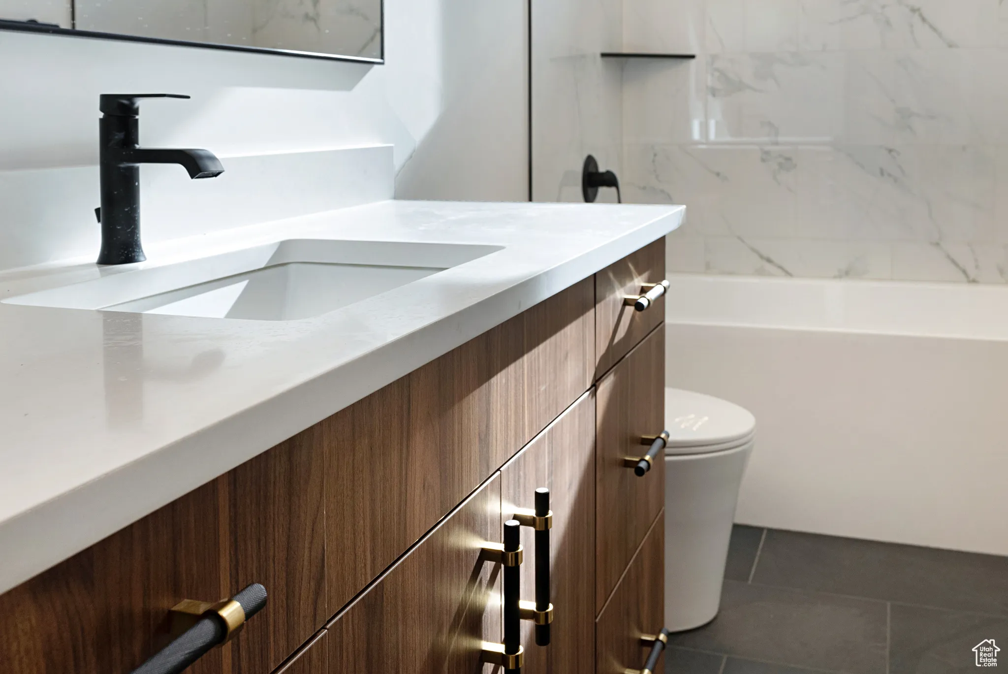Full bathroom featuring vanity, washtub / shower combination, and tile patterned floors
