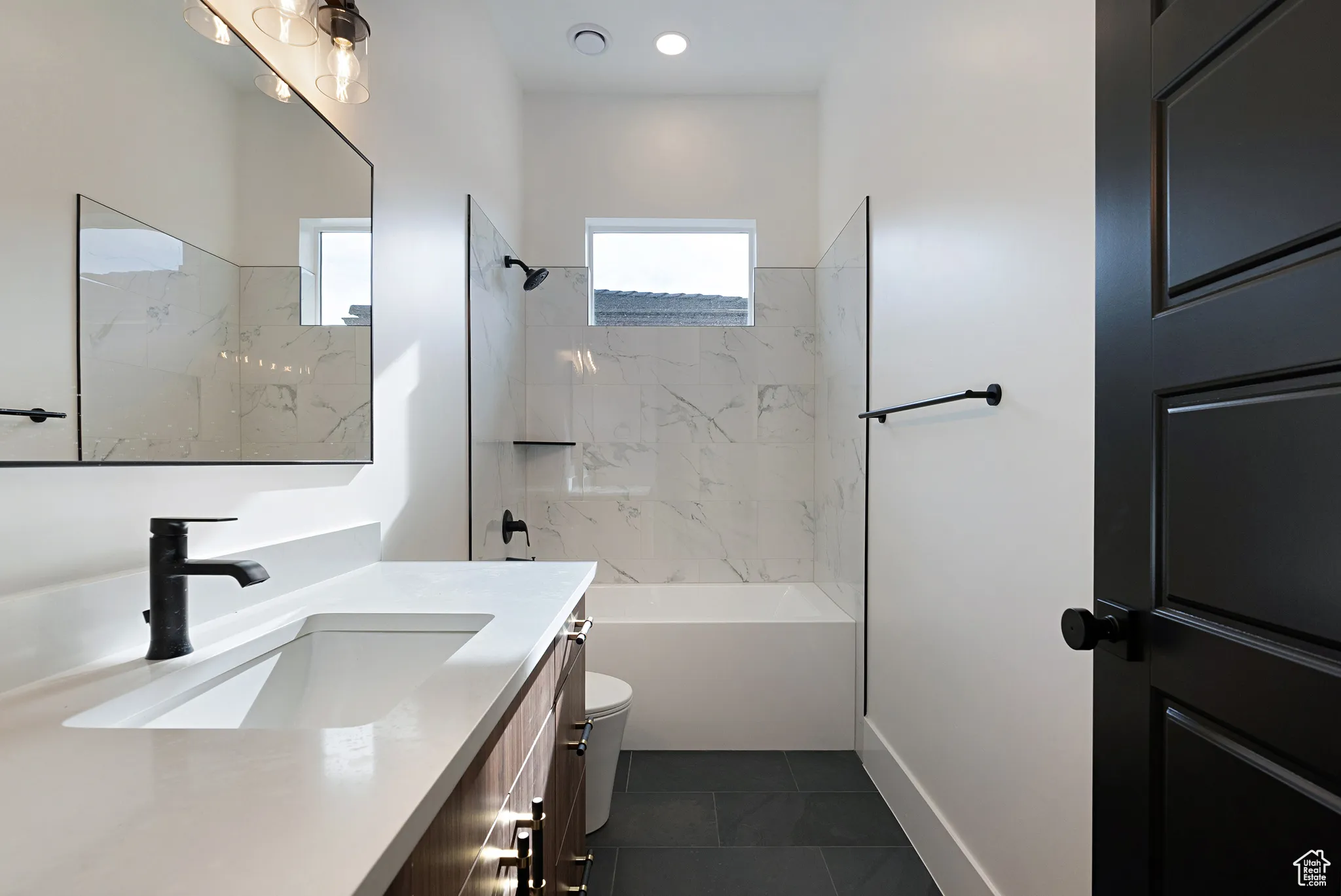 Full bath with vanity, tile patterned flooring, and  shower combination
