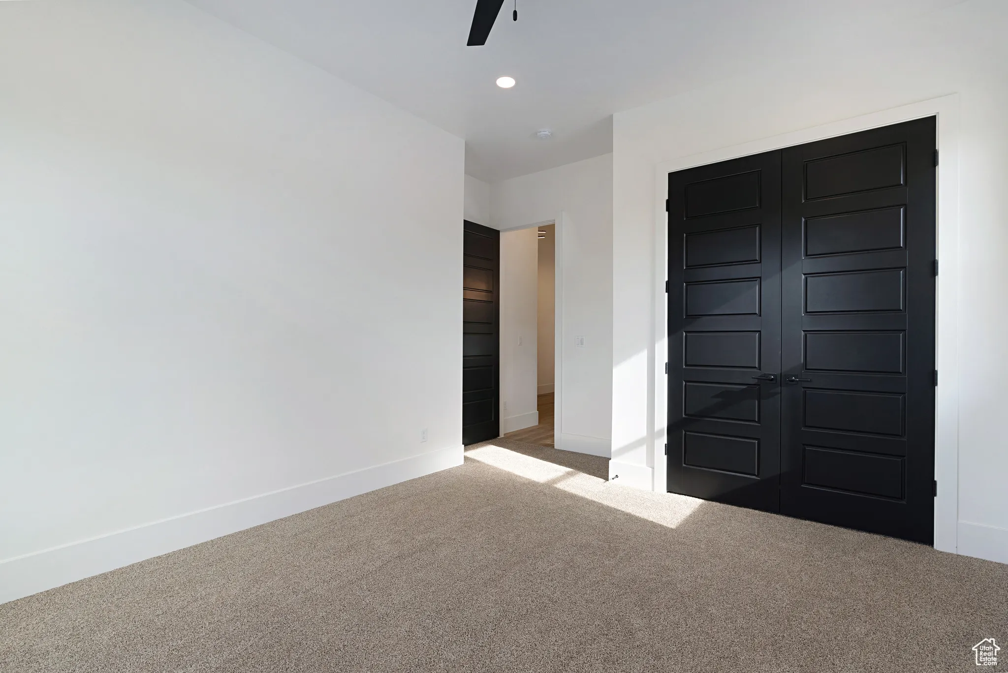 Unfurnished bedroom featuring carpet floors, recessed lighting, a closet, and a ceiling fan