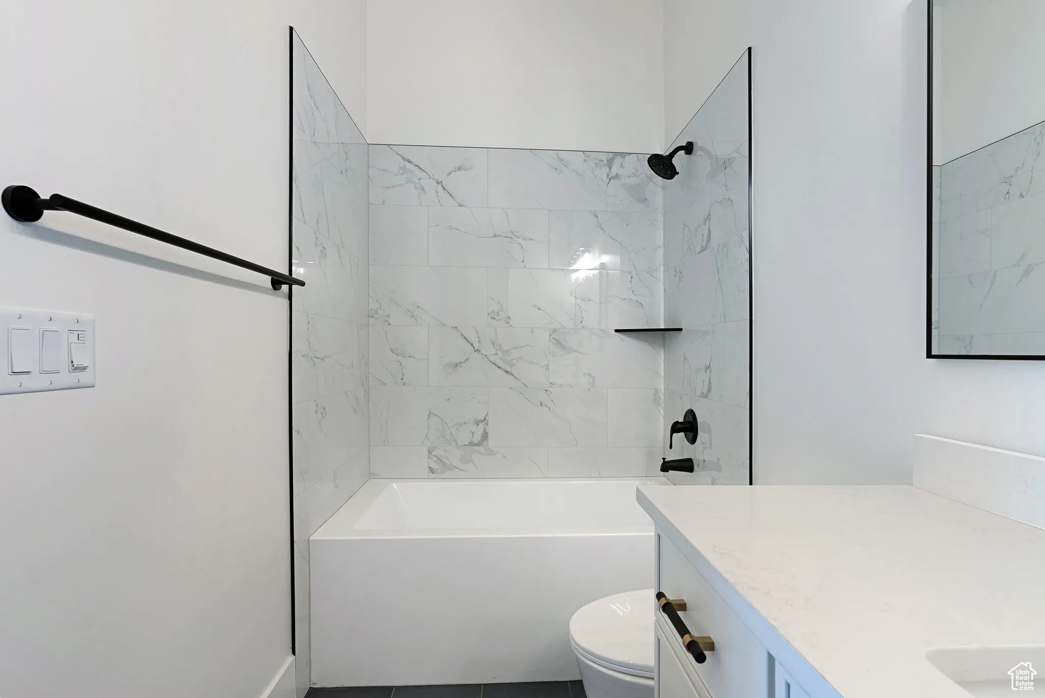Bathroom featuring vanity and  shower combination