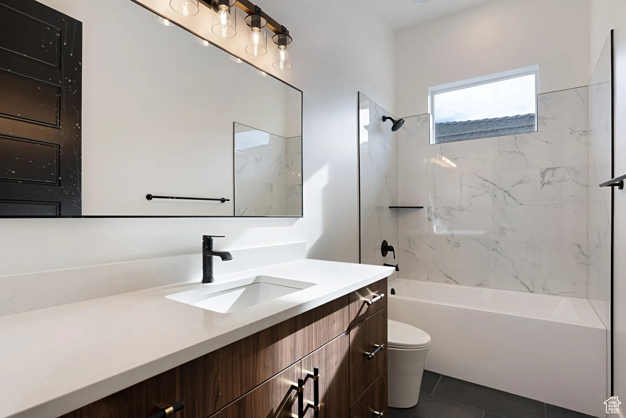 Bathroom with vanity, shower / washtub combination, and tile patterned flooring