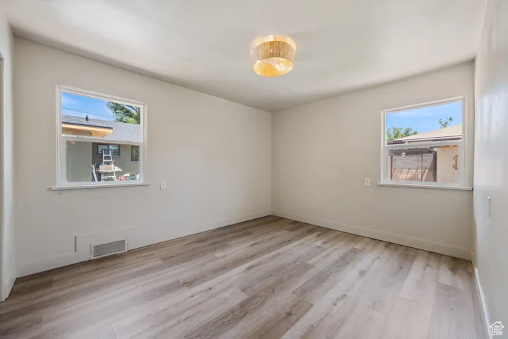 Spare room with light wood-type flooring and baseboards