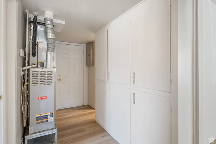 Utility room featuring heating unit