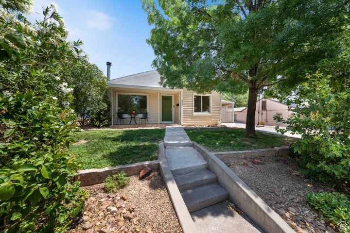 Bungalow-style house with a front lawn and covered porch