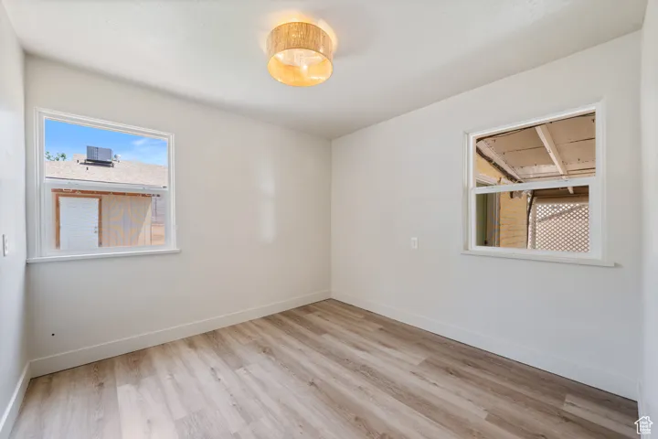 Spare room with light wood finished floors and baseboards