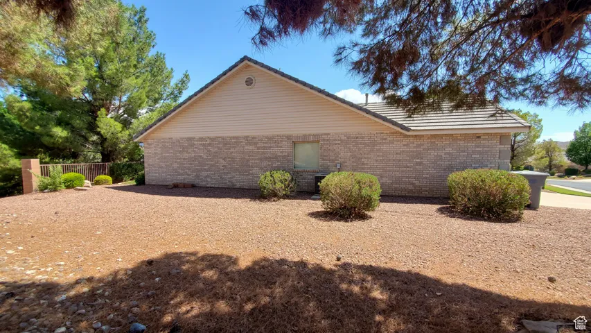 View of side of property featuring brick siding