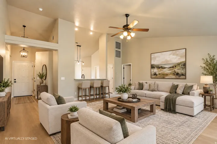Vaulted ceilings, wood-finish flooring, a kitchen island with bar seating, and recessed lighting