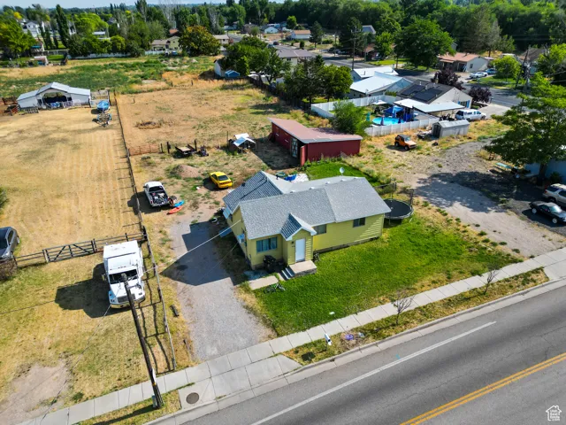 Aerial view of property and surrounding area featuring a pool