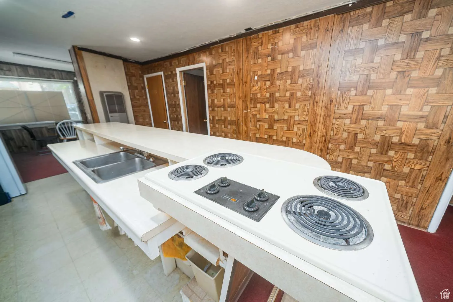 Kitchen featuring white electric cooktop and light countertops