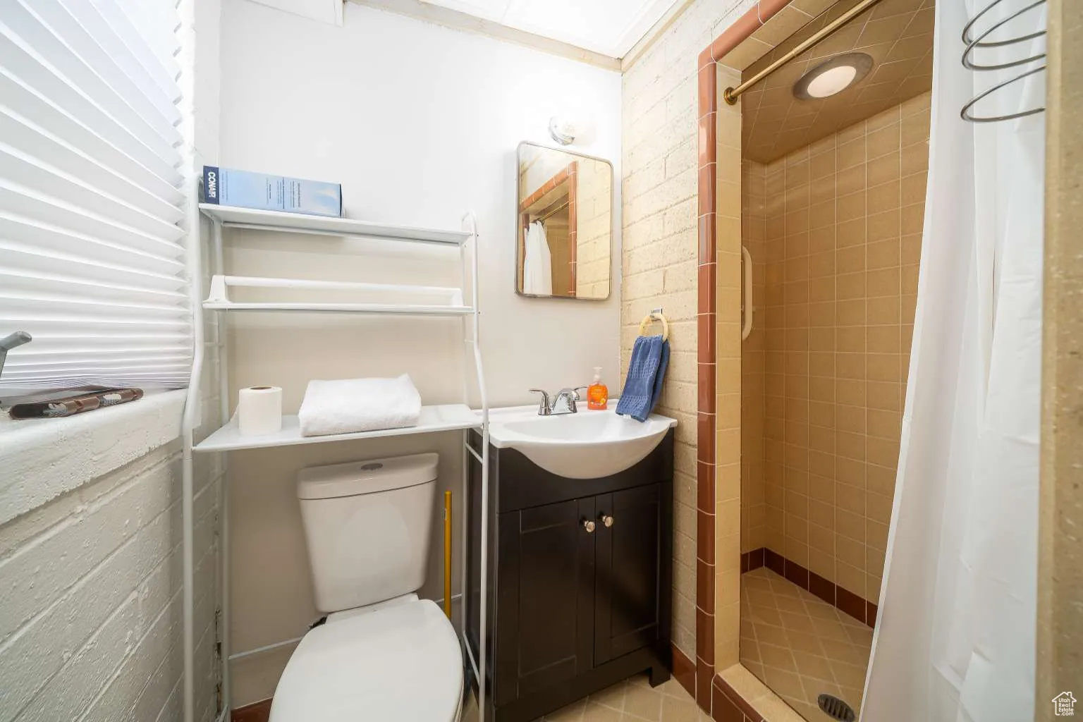 Full bathroom with a shower stall and vanity