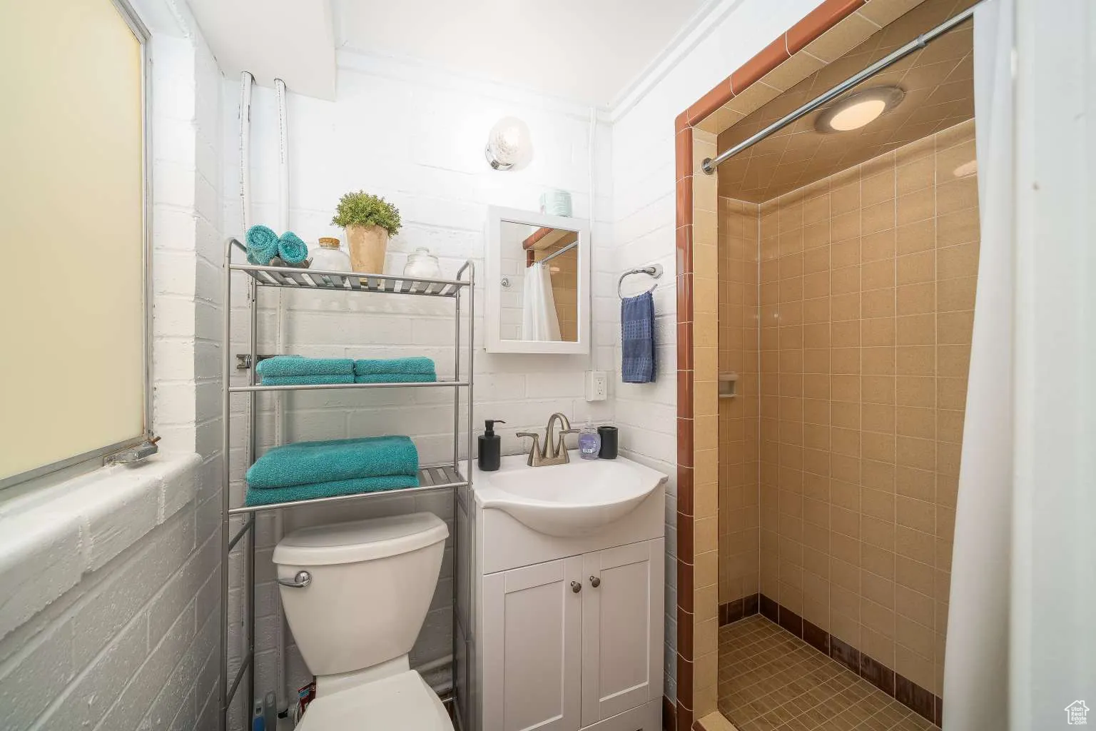 Bathroom featuring vanity, a shower stall, and ornamental molding