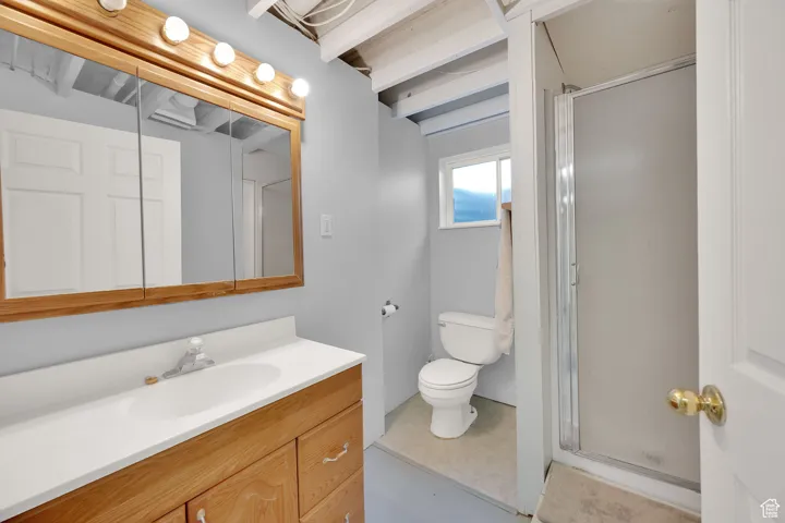 Bathroom featuring vanity and a stall shower