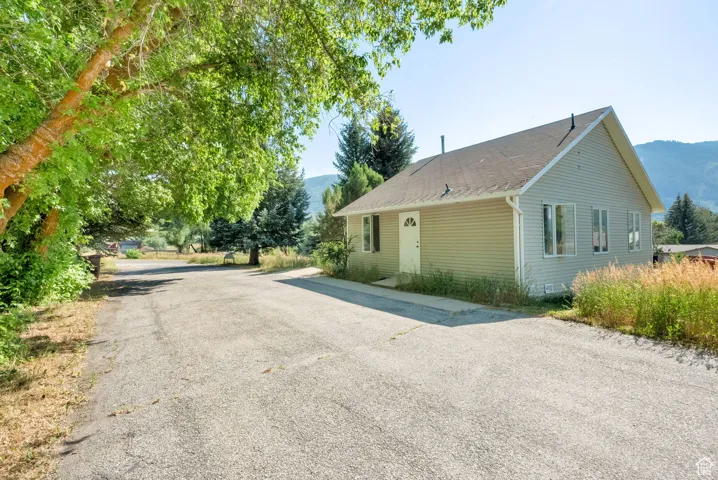 View of side of property with a mountain view