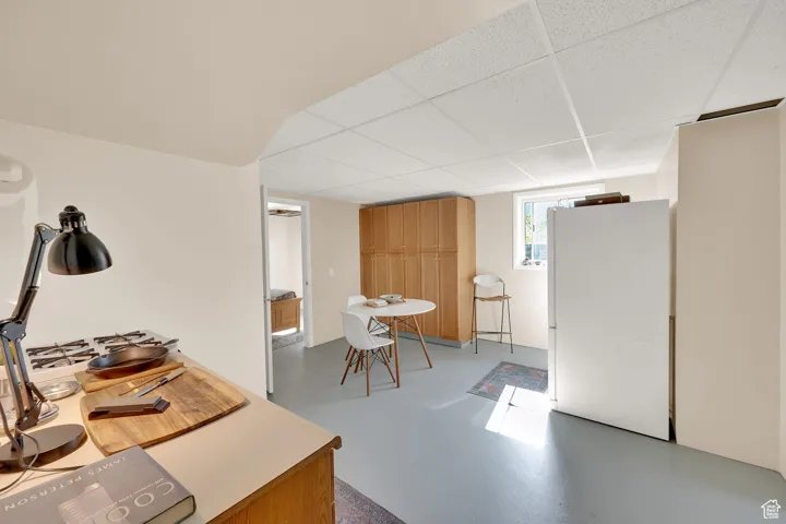 Interior space with finished concrete floors and a paneled ceiling