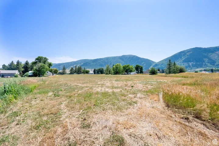 View of mountain backdrop featuring rural landscape