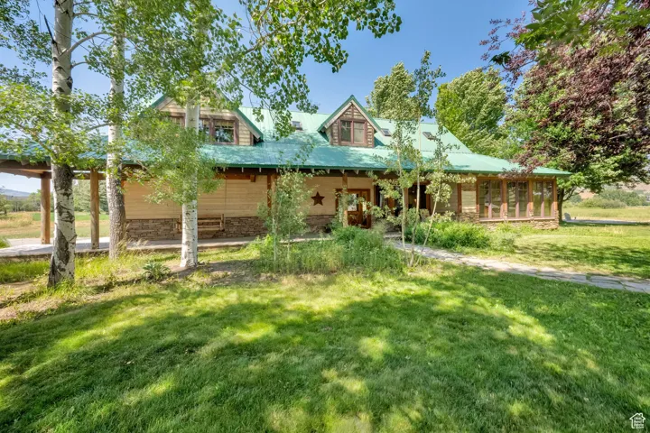 Farmhouse-style home featuring a front lawn