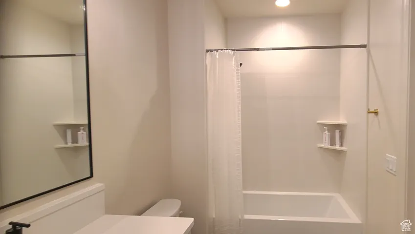 Full bath featuring shower / bath combo and vanity