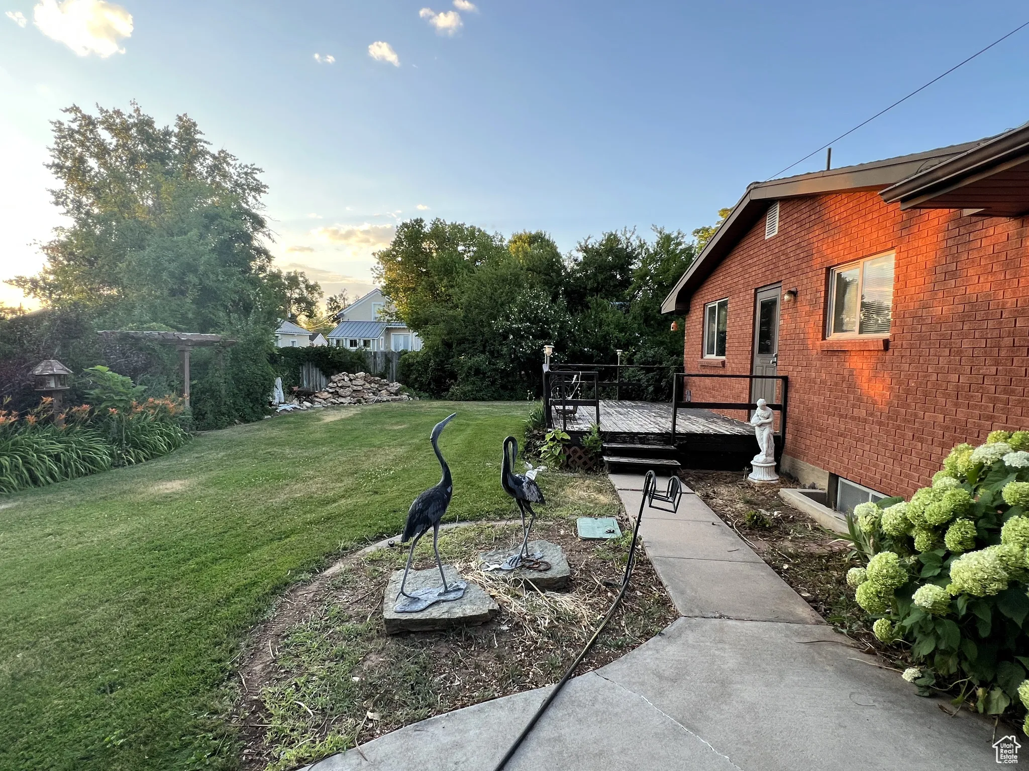 View of grassy yard with a deck