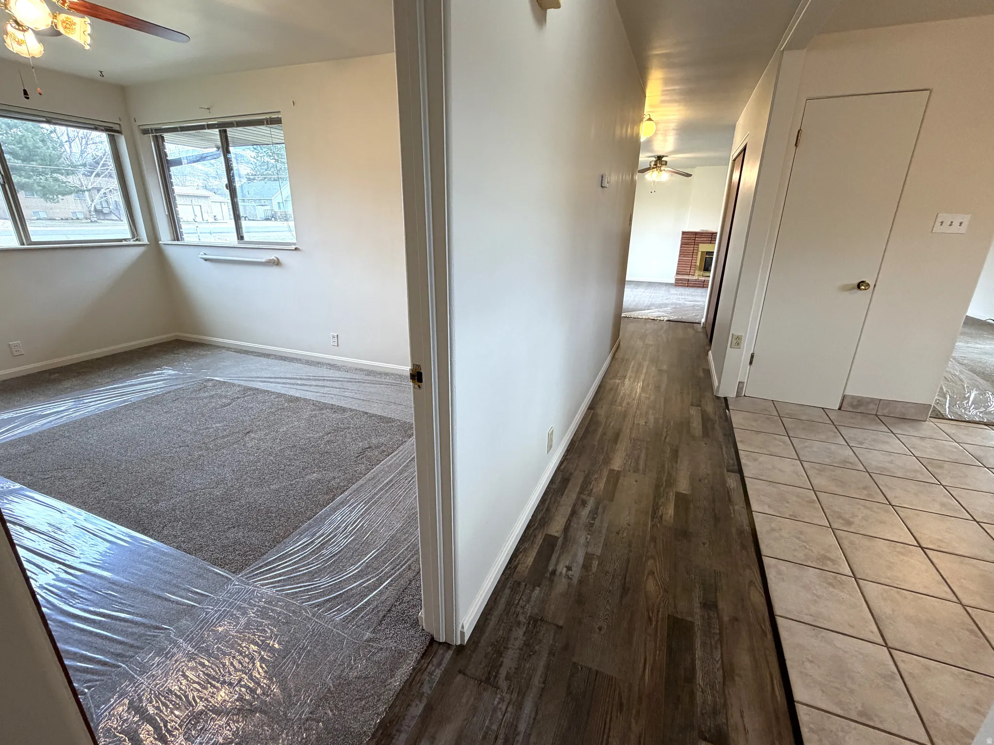 Corridor with baseboards and light wood-style flooring