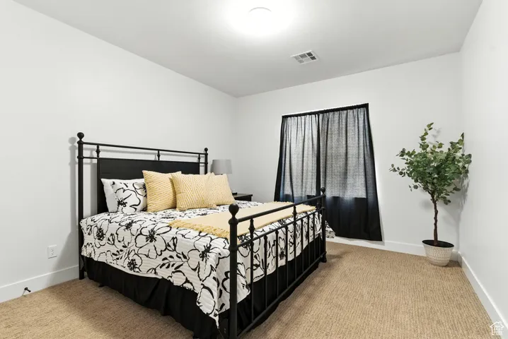 Carpeted bedroom with baseboards