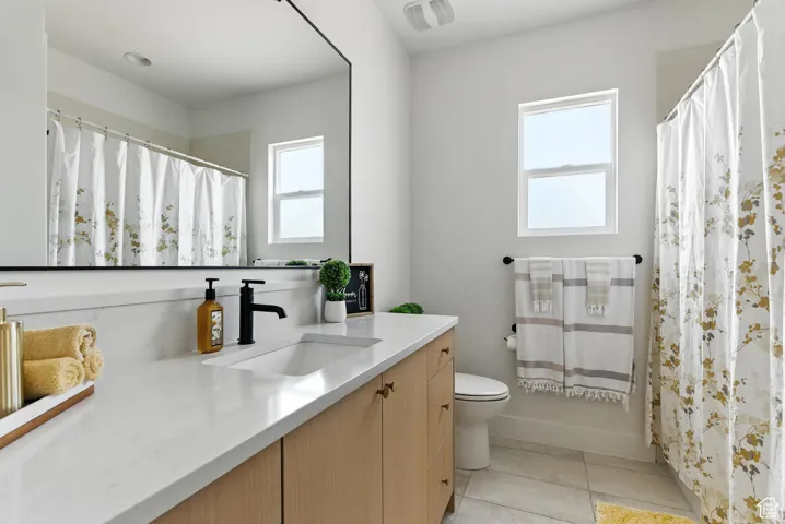 Full bath featuring vanity, tile patterned flooring, and a shower with shower curtain
