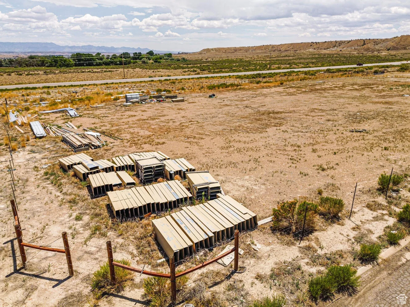 Aerial view of sparsely populated area with a mountainous background and a desert landscape