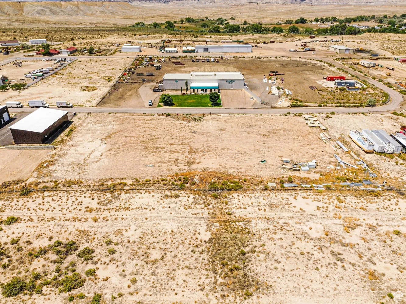 Overview of rural landscape with a desert landscape and a mountain backdrop