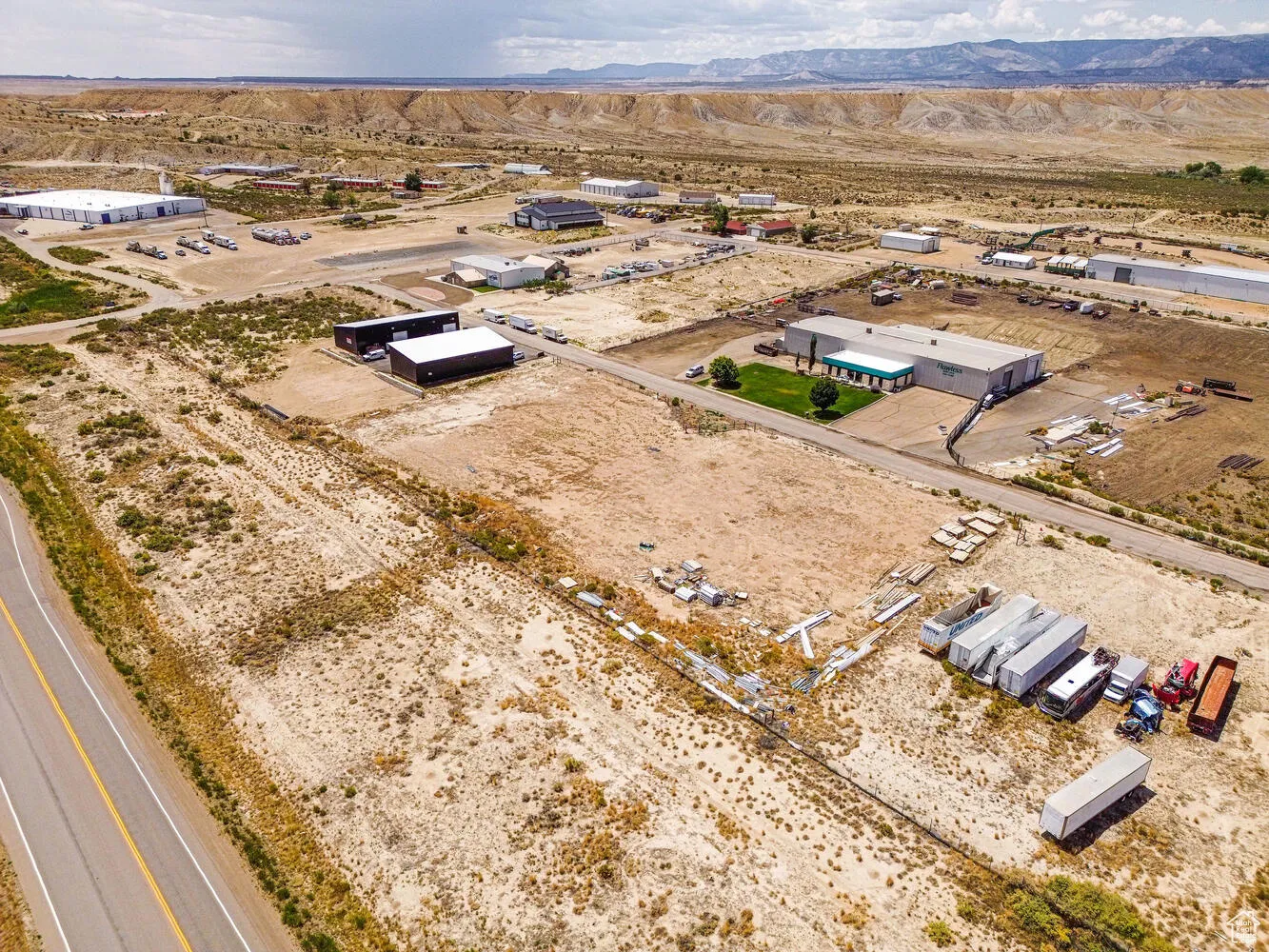Aerial view of sparsely populated area featuring a desert landscape and a mountain backdrop