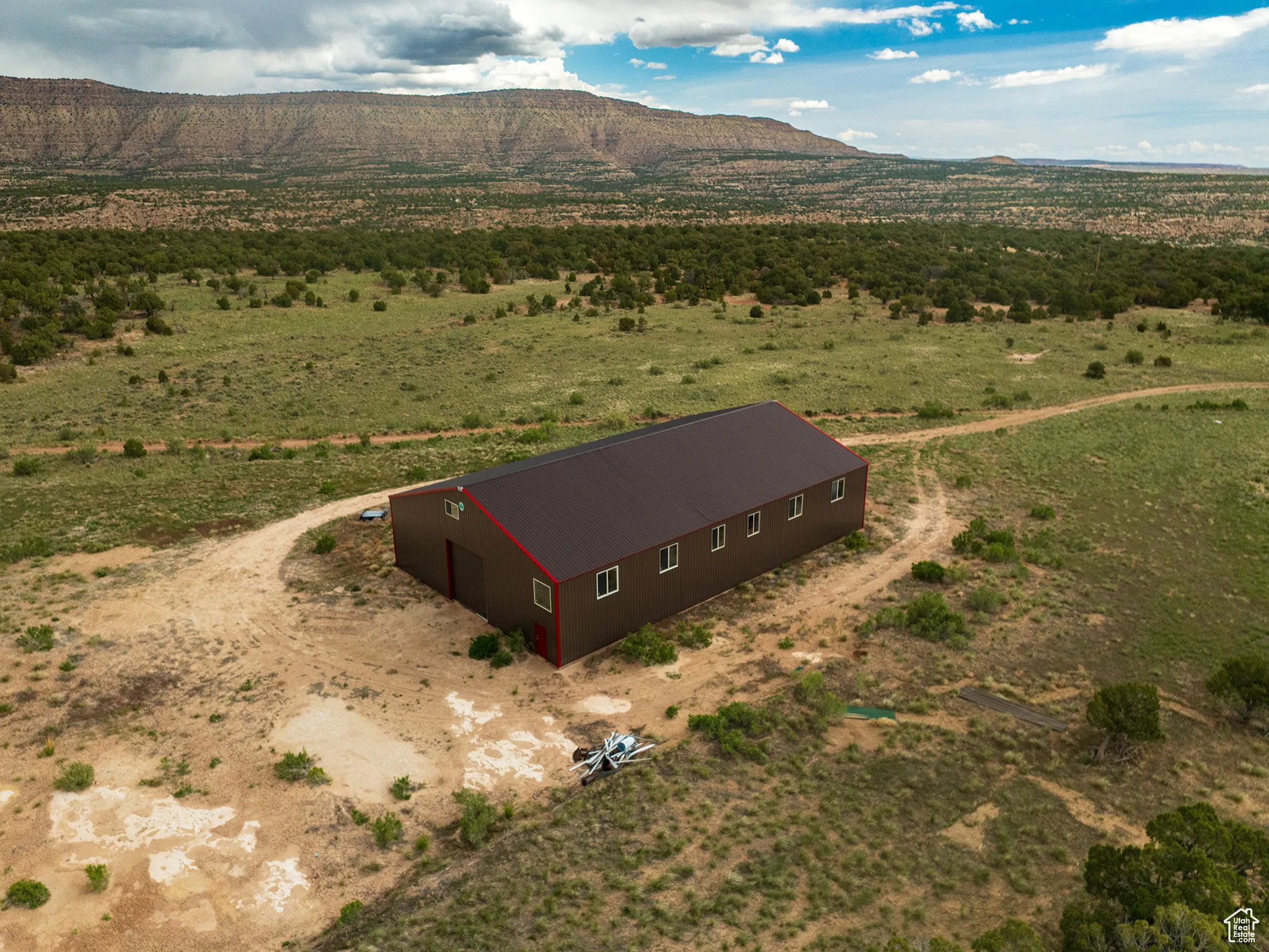Aerial view of sparsely populated area featuring mountains and 60 X 90 Pole Barn Building