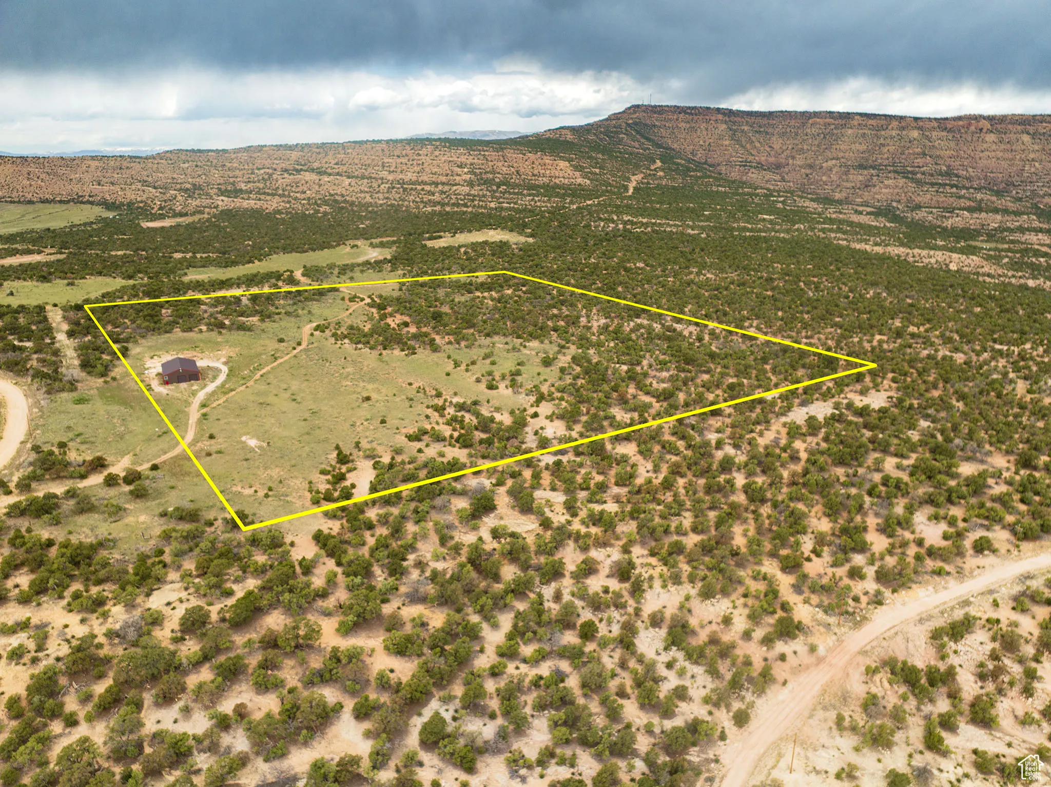 Aerial view of sparsely populated area with property boundaries highlighted and mountains