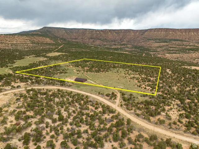 Overview of rural landscape with mountains and property parcel outlined