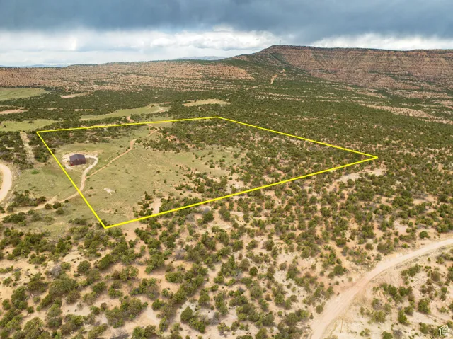 Aerial view of sparsely populated area with property boundaries highlighted and mountains