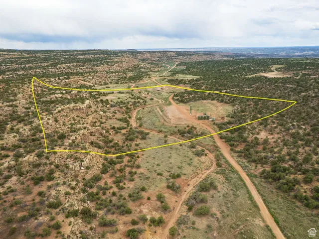 Aerial view of sparsely populated area featuring property parcel outlined